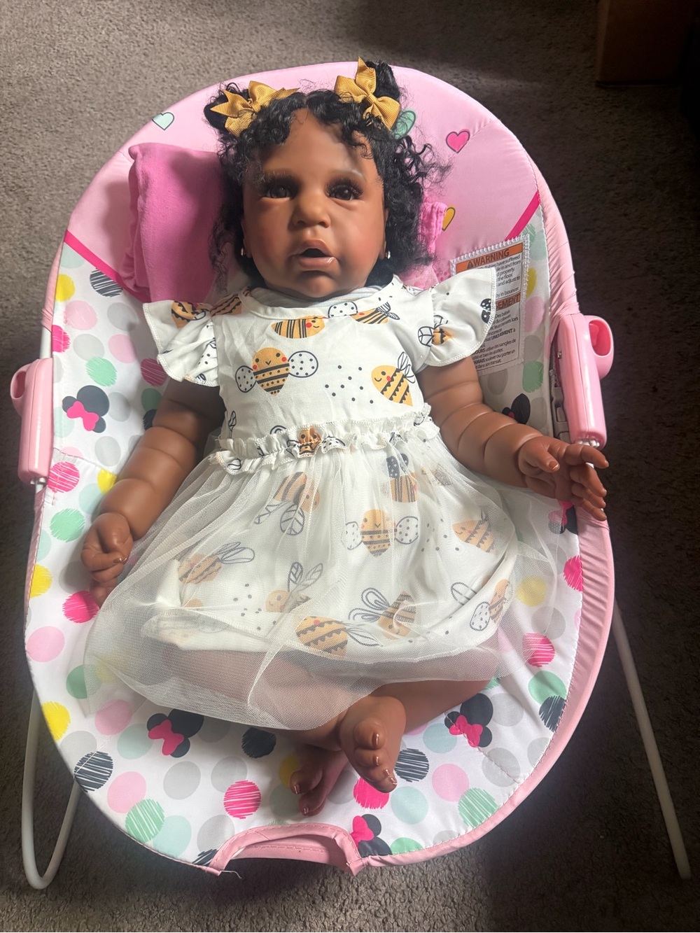 Reborn Brown Baby Doll in Pink Floral Bouncer with Yellow Bows